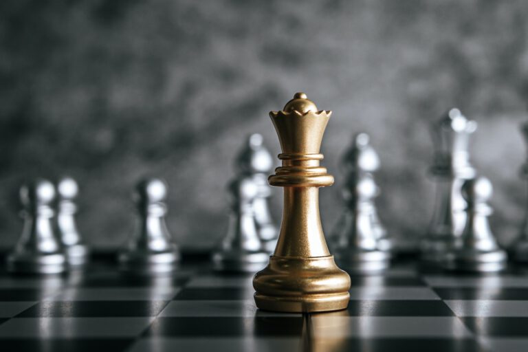 Gold and Silver Chess on chess board game for business metaphor leadership concept